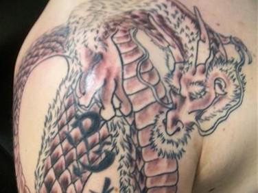 draken tattoo onderarm